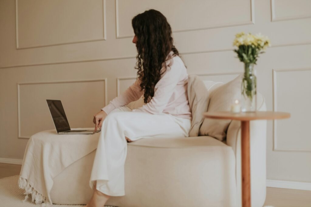 A woman practicing self-discipline and self-respect for women by working calmly on her laptop in a peaceful, intentional environment.