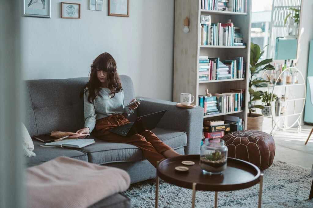 Woman journaling in a cozy living space as part of her daily routine to become the woman she wants to be