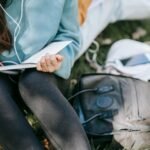 A woman journaling outdoors while reflecting on the fear of being seen and learning to reclaim her voice.
